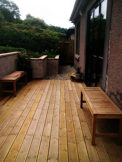 Timber Decking to patio doors with rendered walls and timber copings.