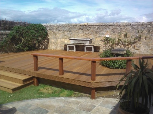 Hardwood timber decking with stone trough barbecue.